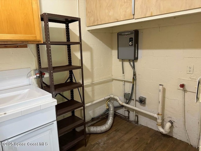 laundry area featuring dark wood-type flooring, cabinets, and hookup for an electric dryer