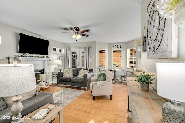 828 Parkwood Ave, Titusville, FL 32796 - living area with a ceiling fan, light wood finished floors, and a fireplace