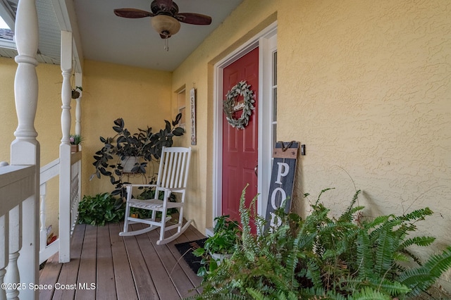 828 Parkwood Ave, Titusville, FL 32796 - property entrance with ceiling fan and stucco siding