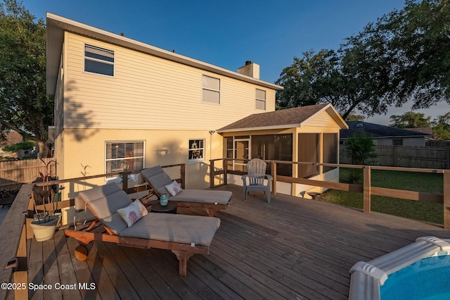 828 Parkwood Ave, Titusville, FL 32796 - wooden deck with a sunroom and a fenced backyard