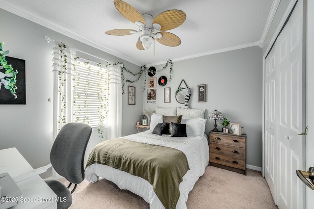 828 Parkwood Ave, Titusville, FL 32796 - bedroom with a closet, crown molding, light carpet, a ceiling fan, and baseboards