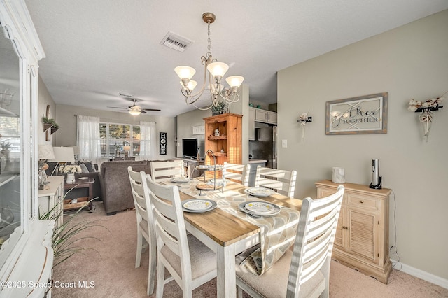 828 Parkwood Ave, Titusville, FL 32796 - dining area featuring light colored carpet, a chandelier, ceiling fan, and baseboards