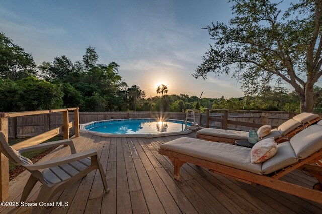 828 Parkwood Ave, Titusville, FL 32796 - view of pool with a deck, a fenced backyard, and view of wooded area