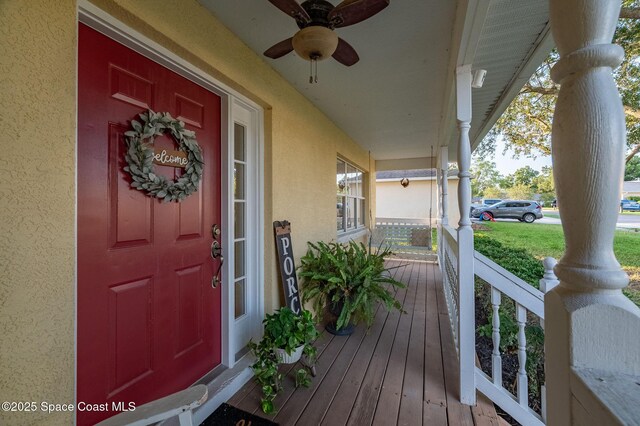 828 Parkwood Ave, Titusville, FL 32796 - property entrance featuring a porch, stucco siding, and ceiling fan