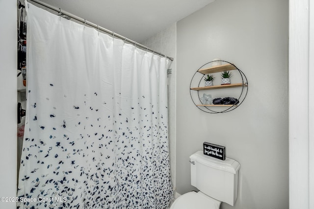 828 Parkwood Ave, Titusville, FL 32796 - bathroom with toilet and a shower with shower curtain