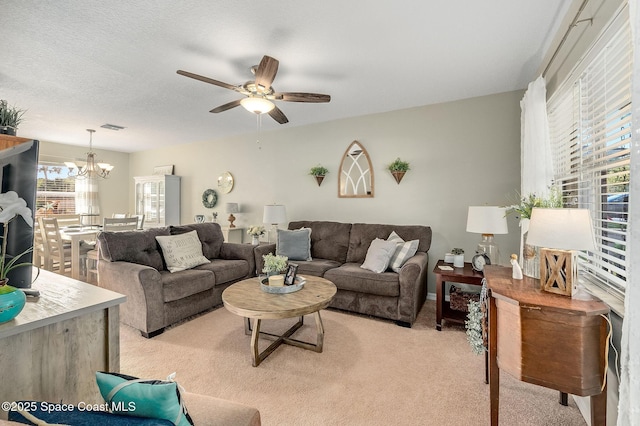 828 Parkwood Ave, Titusville, FL 32796 - living area with plenty of natural light, light carpet, a ceiling fan, and a chandelier