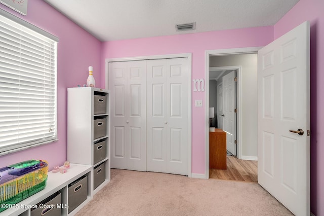 828 Parkwood Ave, Titusville, FL 32796 - bedroom featuring light colored carpet, a closet, and baseboards
