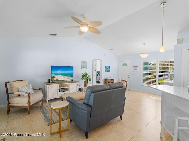 living room featuring lofted ceiling, ceiling fan, and light tile patterned flooring