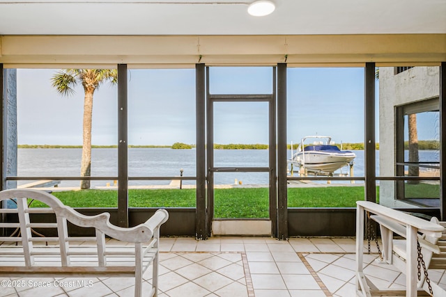 sunroom / solarium featuring a healthy amount of sunlight and a water view