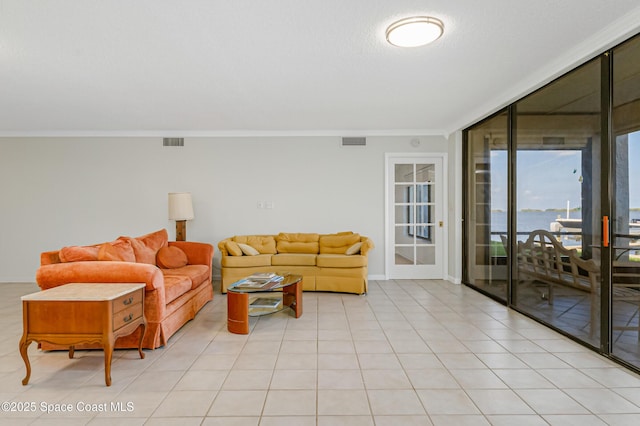 tiled living room featuring a water view, expansive windows, and crown molding