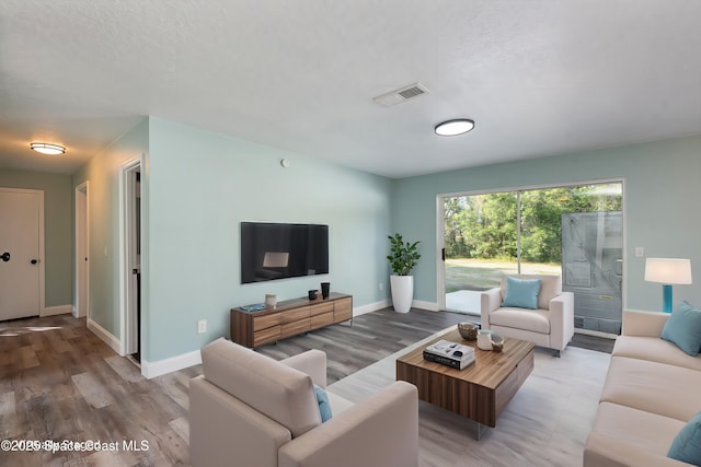 living room featuring hardwood / wood-style flooring and a textured ceiling