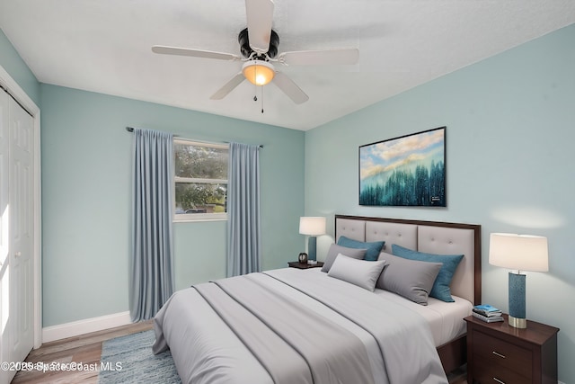 bedroom featuring hardwood / wood-style floors, a closet, and ceiling fan