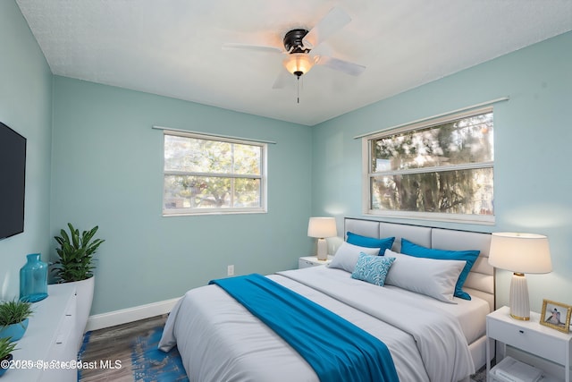 bedroom featuring dark hardwood / wood-style floors and ceiling fan