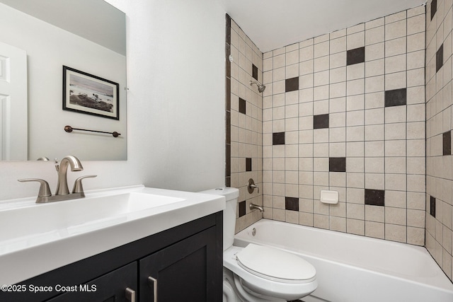 full bathroom with vanity, toilet, and tiled shower / bath