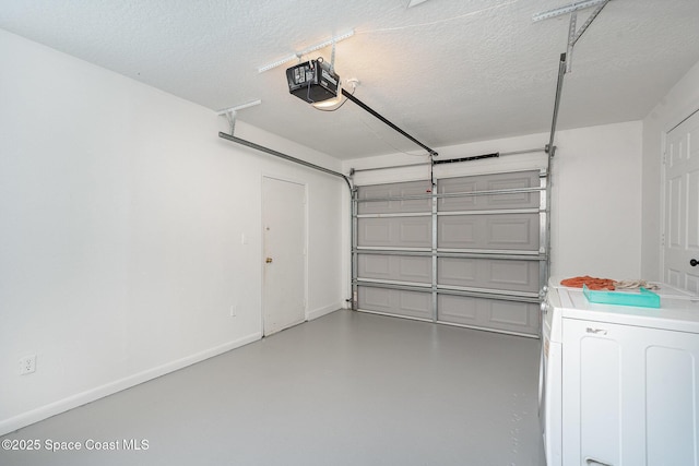 garage with a garage door opener and washer / dryer