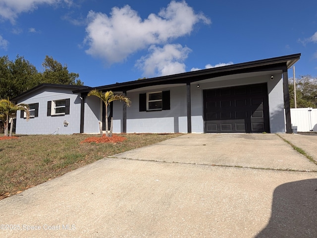 ranch-style home featuring a garage and a front yard