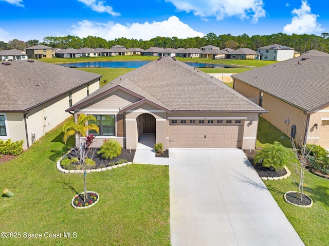 ranch-style home featuring a garage, a water view, and a front yard