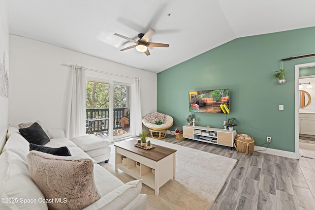 living room with hardwood / wood-style flooring, lofted ceiling, and ceiling fan