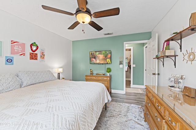 bedroom with ceiling fan and wood-type flooring