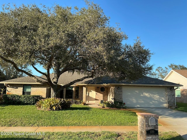 single story home featuring a garage and a front yard