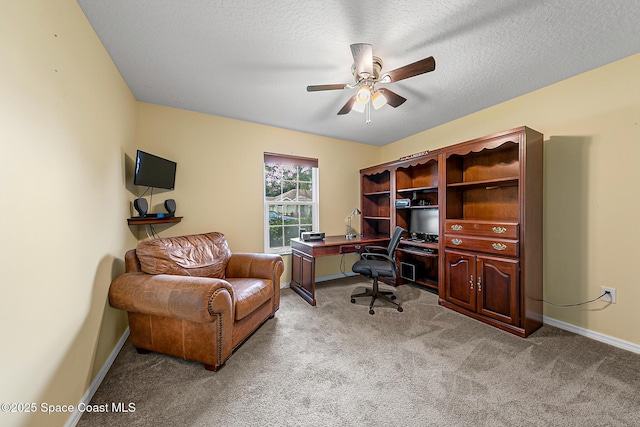 home office with ceiling fan, light colored carpet, and a textured ceiling