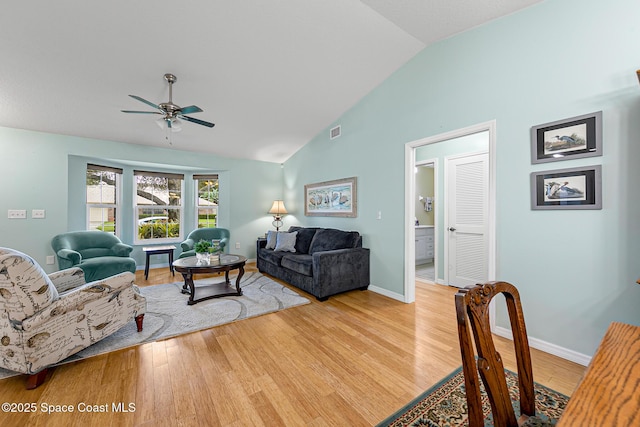 living room with ceiling fan, high vaulted ceiling, and light hardwood / wood-style flooring