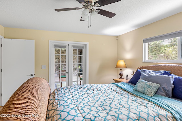 bedroom featuring french doors, ceiling fan, access to exterior, and a textured ceiling