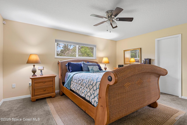 carpeted bedroom with a textured ceiling and ceiling fan