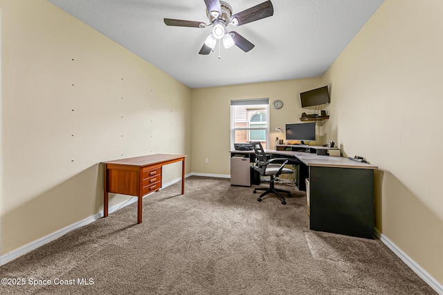 carpeted office featuring ceiling fan