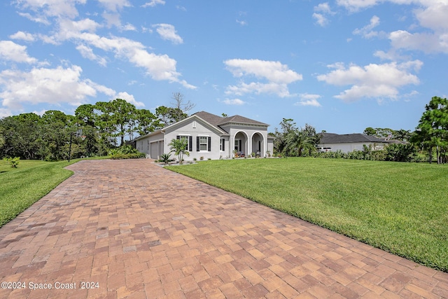 mediterranean / spanish-style home with a garage and a front yard