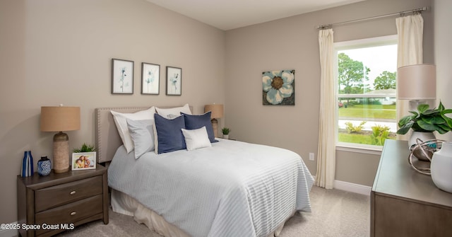 bedroom featuring light colored carpet