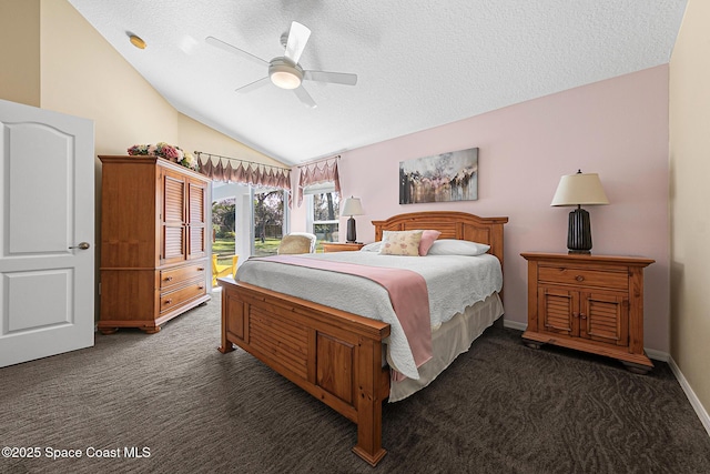 bedroom with ceiling fan, a textured ceiling, access to outside, dark carpet, and vaulted ceiling