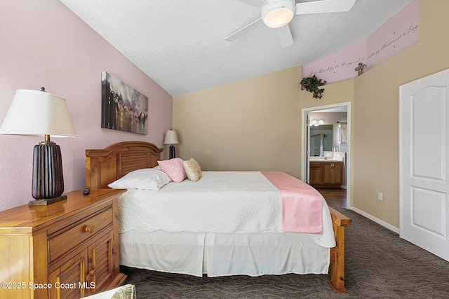 bedroom with lofted ceiling, ceiling fan, connected bathroom, a textured ceiling, and dark carpet