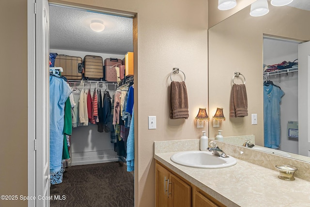 bathroom with vanity and a textured ceiling