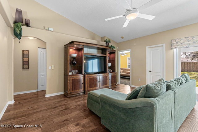 living room with vaulted ceiling, dark hardwood / wood-style floors, and ceiling fan