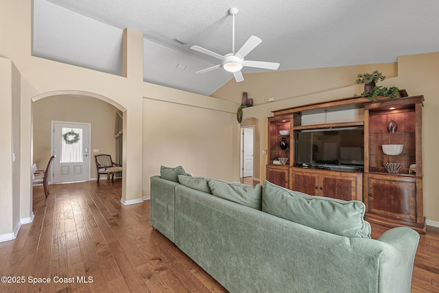 living room featuring hardwood / wood-style floors, a textured ceiling, vaulted ceiling, and ceiling fan