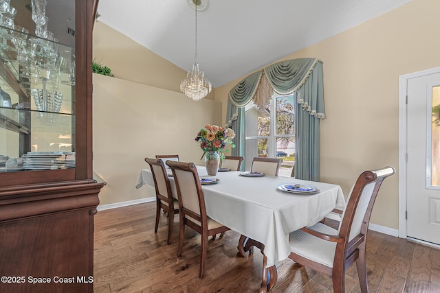 dining area with hardwood / wood-style flooring and lofted ceiling