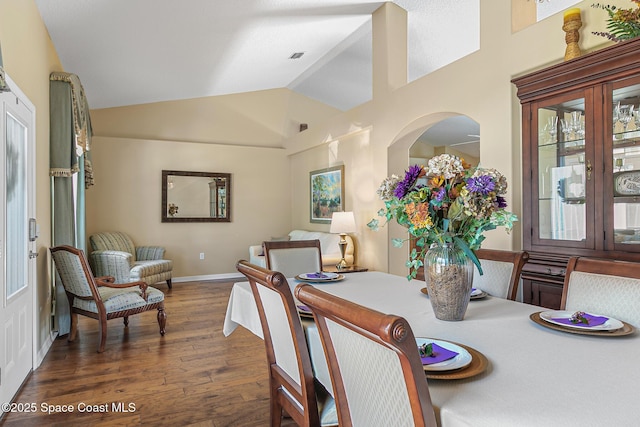 dining space with lofted ceiling and dark hardwood / wood-style floors