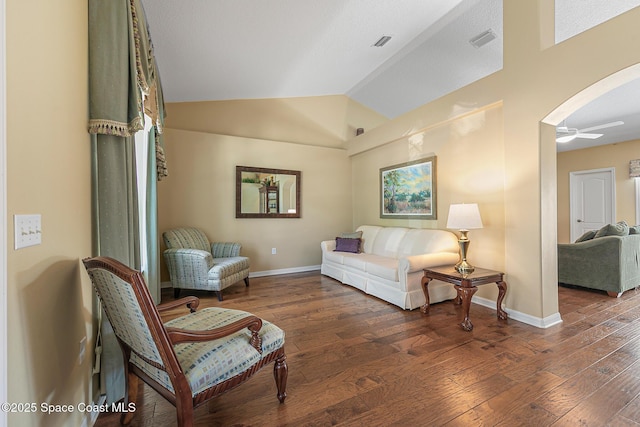 living room with vaulted ceiling, dark hardwood / wood-style floors, and ceiling fan