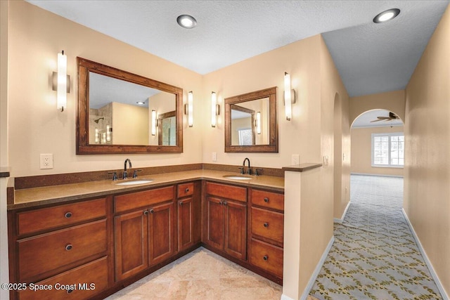 bathroom with vanity and a textured ceiling