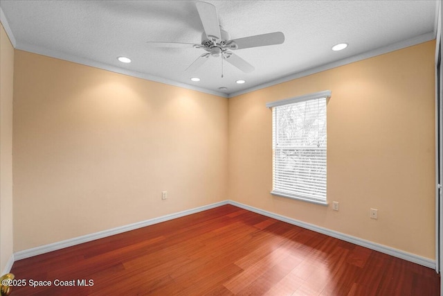 empty room with hardwood / wood-style flooring, ceiling fan, ornamental molding, and a textured ceiling