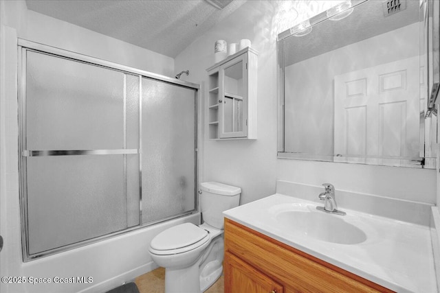 full bathroom featuring vanity, toilet, shower / bath combination with glass door, and a textured ceiling