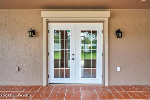 view of exterior entry featuring french doors