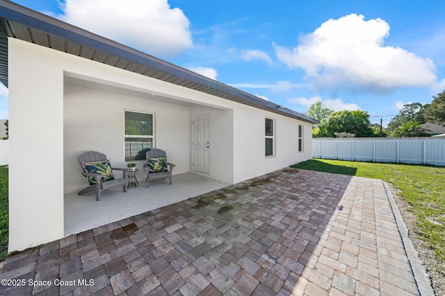 view of patio / terrace featuring fence