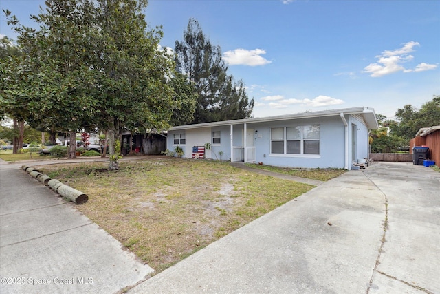 225 Court St, Titusville, FL 32780 - view of front of property with concrete driveway, stucco siding, and a front yard