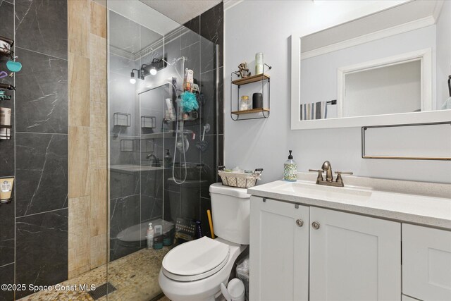 225 Court St, Titusville, FL 32780 - bathroom featuring toilet, vanity, a tile shower, and ornamental molding