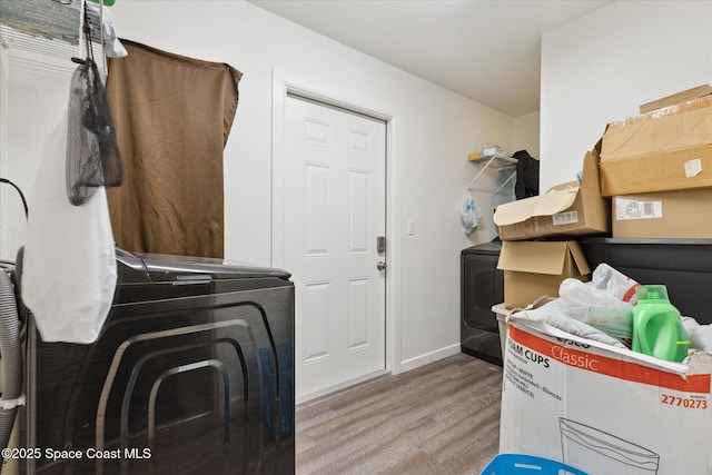 225 Court St, Titusville, FL 32780 - washroom featuring wood finished floors, washing machine and clothes dryer, and baseboards