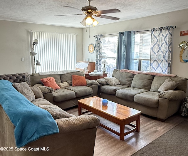 225 Court St, Titusville, FL 32780 - living room with a textured ceiling, wood finished floors, and a ceiling fan