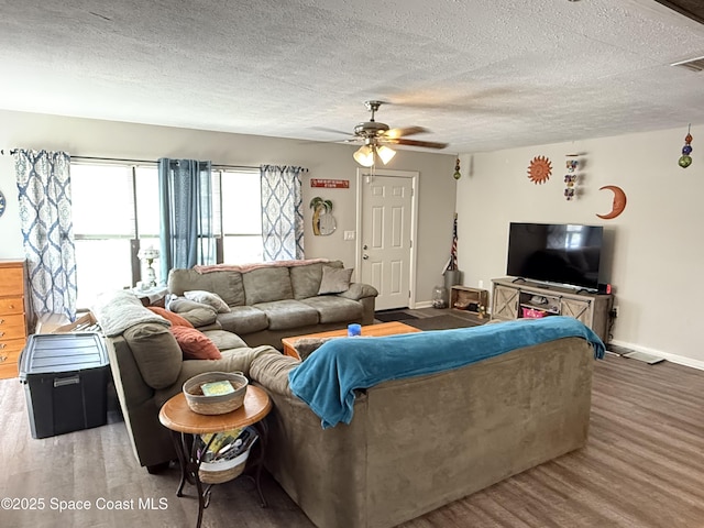 225 Court St, Titusville, FL 32780 - living room with ceiling fan, wood finished floors, baseboards, and a textured ceiling