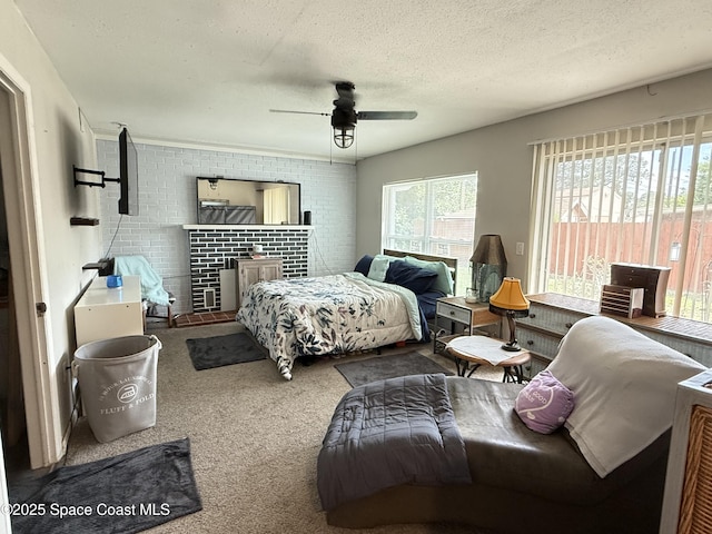 225 Court St, Titusville, FL 32780 - carpeted bedroom with access to outside, brick wall, a ceiling fan, and a textured ceiling